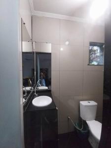 ドゥケ・デ・カシアスにあるLinda casa 10 min aeroporto home officeの洗面台、トイレ、鏡のあるバスルーム