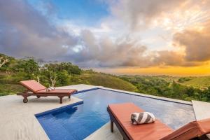 a swimming pool with a view of the mountains at Pini Sentana Village Nusa Penida in Nusa Penida