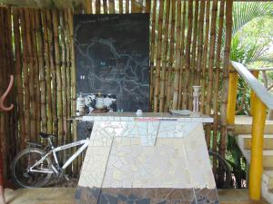 a table and a bike parked next to a chalkboard at Dunarinka in Minca +81 photos