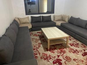 a living room with a couch and a coffee table at Sablet mohammedia in Pont Blondin +2 photos