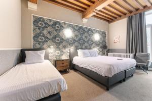 Postel nebo postele na pokoji v ubytování Hotel karel de stoute