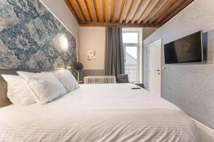 Postel nebo postele na pokoji v ubytování Hotel karel de stoute