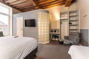 Postel nebo postele na pokoji v ubytování Hotel karel de stoute