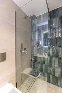 a shower with a glass door in a bathroom at Enalia Luxury Living in Nikiti +45 photos