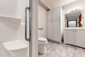 a white bathroom with a toilet and a sink at Thompson Lake Estate in Poland +64 photos