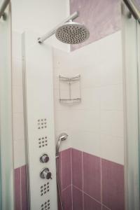 a bathroom with a shower with purple and white tiles at Vossia Casa Vacanze in Acquedolci +76 photos