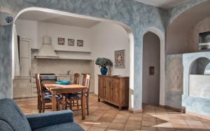 a kitchen and dining room with a table and chairs at Le Terrazze Sul Pevero in Porto Cervo +10 photos