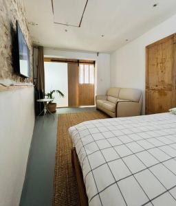 a bedroom with a bed and a living room with a couch at Maison Marseille Vauban in Marseille