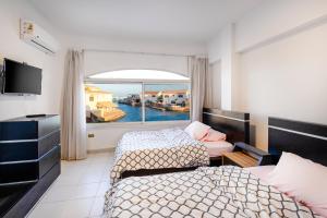 a hotel room with two beds and a window at Aden Beach - Sea View room with beach access in Villa in Hurghada