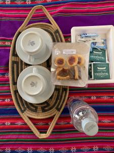 a tray with plates and a bag of donuts on a table at Cabaña Cortaderas MI Campito Cachi Salta in Cachí