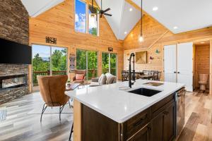 a kitchen with a fireplace and a living room at Butterfly Lookout in Dandridge