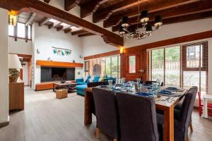 a dining room with a table and a living room at Incredible Property with Huge Garden and Pool! in Valle de Bravo