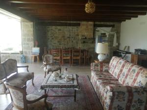 a living room with a couch and chairs and a table at Silentium Domus in Gornje Vreme