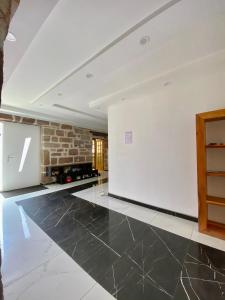 an empty living room with a stone wall at Chambres d'hôtes - La correziene in Allassac