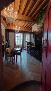 a kitchen with a table and a dining room at Meublé de caractère Les arts Danse in Le Puy-en-Velay