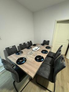 a dining room table with chairs and a wooden tableablish at Big House I 15 Beds I 8 Sleeping Room I Parking in Bad Oeynhausen