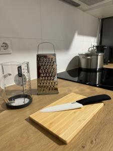 a cutting board with a knife and a blender on a counter at Big House I 15 Beds I 8 Sleeping Room I Parking in Bad Oeynhausen