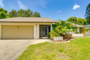 a house with a garage and a palm tree at Pet-Friendly Home with Pool, Close to Venice Beaches in Venice