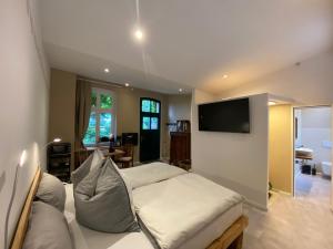 a bedroom with a bed and a flat screen tv at St Moritz 2 Quadenschönfeld in Möllenbeck