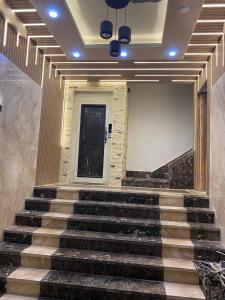 a staircase in a building with a door and a stair case at شقة فندقية على البحر 3 in Hurghada