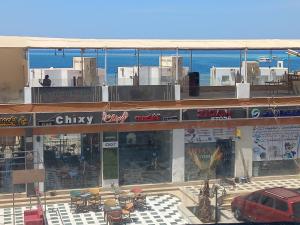 a building with a car parked in front of it at شقة فندقية على البحر 3 in Hurghada