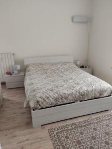 a bedroom with a bed in a white room at Casa Berna in Rome