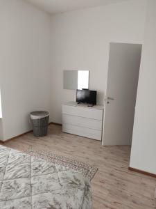 a white room with a television and a white door at Casa Berna in Rome