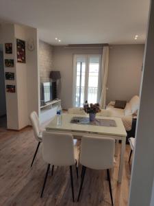 a kitchen and living room with a table and chairs at Casa Berna in Rome +2 photos