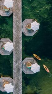 an overhead view of boats and umbrellas in the water at Matachica Beach Resort and Spa in San Pedro
