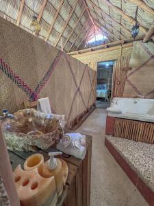 a bathroom with a tub and a sink in a tent at Finca las Isabeles in Xochitepec