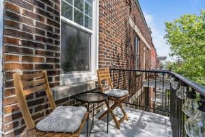 a balcony with two chairs and a table and a window at Appartement haut de gamme NDG in Montreal