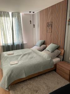 A bed or beds in a room at Péterfia Boutique Apartments