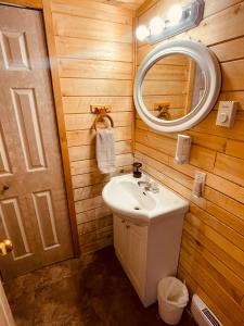 a bathroom with a sink and a mirror at Summit River Lodge & Campsites in Valemount +49 photos