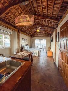 a kitchen with a sink and a bed in a room at BAJA MÍA in Loreto
