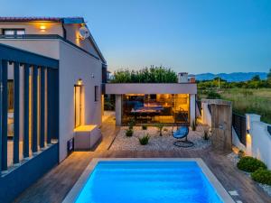 a swimming pool in the backyard of a house at Villa Klara in Privlaka
