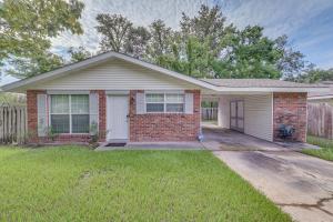 a red brick house with a white garage at Baton Rouge Home with Yard about 14 Mi to Downtown! in Baton Rouge