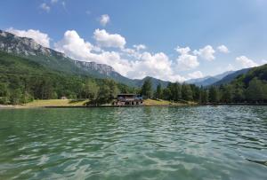 a view of a lake with mountains in the background at Domacinstvo Paprica Tjentiste in Foča