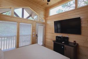 a bedroom with a bed and a flat screen tv at Cabin with a Mountain view 6B in Williams