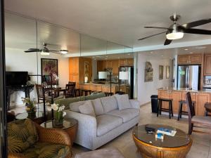 a living room with a couch and a table at Tropical Hawaiian Oceanfront - indigomaui - KR210 in Kahana