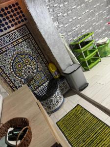 a room with a floor with a tiled floor with mats at City Apartment in M'diq