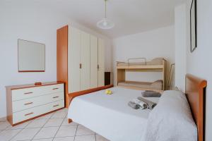 a bedroom with a bed and a bunk bed at Il Giardino dei limoni in Polvica