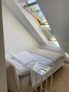 a bedroom with a bed and a glass table at Slow Home in Dziemiany +49 photos