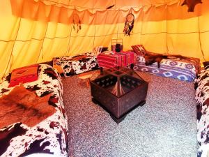 a living room with two couches in a tent at Teepee Camp Lounky in Chodouny