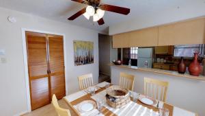 una cucina con tavolo da pranzo e ventilatore a soffitto di Valley Condo 126 - Creekside - WiFi - Hot Tub - Fireplace - Washer - Dryer - Playground a Red River