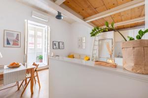 a kitchen with white walls and a table with a potted plant at Our Nest in Il-Furjana