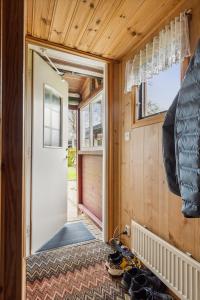 an inside view of a tiny house with a door at Stuga på ringsjös camping in Hörby