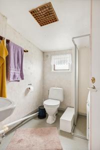 a bathroom with a toilet and a sink at Stuga på ringsjös camping in Hörby