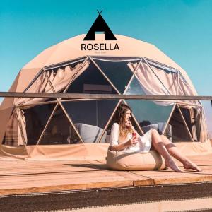 a woman is sitting inside of a tent at ROSELLA Wadi Rum in Disah
