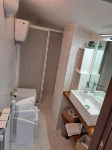 a bathroom with a sink and a toilet at La Casa di Lella in Città della Pieve +9 photos