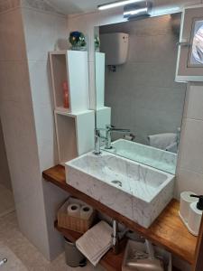 a bathroom with a sink and a mirror at La Casa di Lella in Città della Pieve